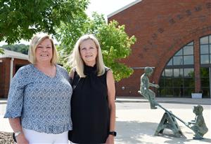 Former Paine Elementary Principal Betsy Schmitt and former Paine Intermediate School Principal Beth Bruno in front of school