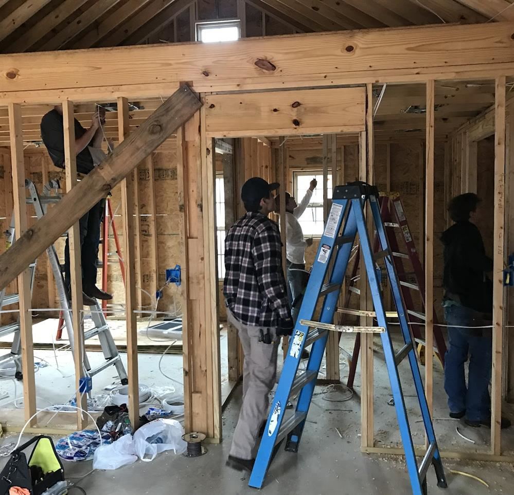 Academy students watch as an instructor shows them how to wire a building. Academy students watch as an instructor shows them how to wire a building.